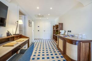 a kitchen with a table and a counter top with a floor at San Montano Resort & Spa in Lacco Ameno