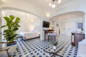 a hotel room with a bed and a living room at San Montano Resort & Spa in Lacco Ameno