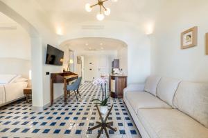 a living room with a couch and a desk at San Montano Resort & Spa in Lacco Ameno