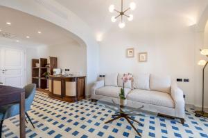 a living room with a couch and a table at San Montano Resort & Spa in Lacco Ameno +174 photos
