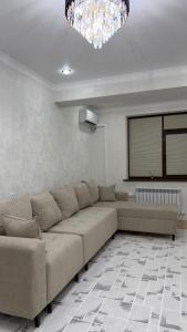 a living room with a couch and a projection screen at АК Кеме in Osh +1 photo