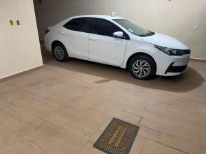 a white car is parked in a garage at Pousada SMART AIRPORT 10 min GRU in Guarulhos