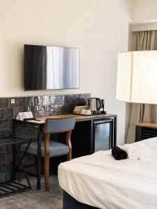 a hotel room with a desk and a bed at The 8 Hotel Budapest in Budapest
