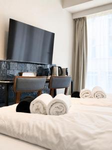 a hotel room with two beds and a table with towels at The 8 Hotel Budapest in Budapest +71 photos