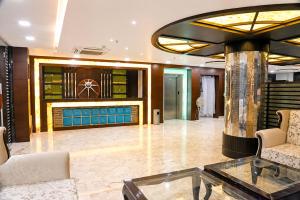 a lobby with two chairs and a glass table at Hotel Nirmla Residency in Brahmapur