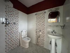 a bathroom with a toilet and a sink at Rock Garden Resort in Pokhara +81 photos