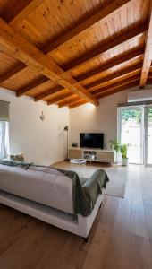 a bedroom with a large bed in a room with wooden ceilings at Casinha do Orjal in Ponte de Lima