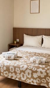 a bedroom with a bed with two towels on it at Casinha do Orjal in Ponte de Lima +19 photos