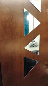a close up of a wooden door with a mirror at Petit Flocon in Pila +28 photos