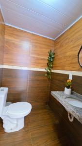 a bathroom with a toilet and a sink at Home Hostel Maceió in Maceió