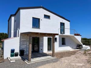 a white house with an open door at BnB Paradiso in Carloforte