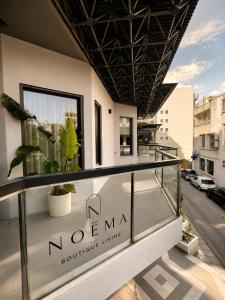 a balcony with a sign that reads novena rooftop living at Noema City View in Xanthi