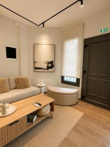 a living room with a couch and a coffee table at Noema City View in Xanthi