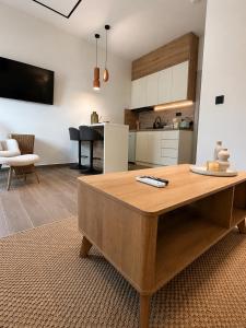 a kitchen and living room with a wooden table at Noema City View in Xanthi +7 photos