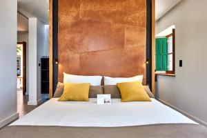 a bedroom with a large white bed with yellow pillows at Lighthouse on La Palma Island in Barlovento +21 photos