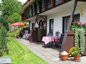 a patio with a table and chairs on a house at Haus Schäfer in Menzenschwand