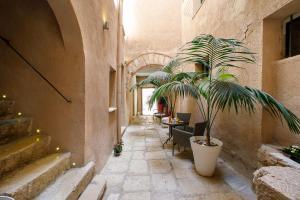 a hallway with a potted plant in a building at Secret B&B in Trapani