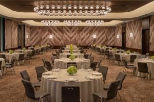 a banquet hall with tables and chairs and a chandelier at W Nashville in Nashville +134 photos