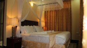 a bedroom with a large bed with a canopy at Tumaini Guest Home in Gathundia