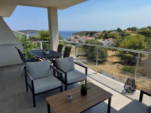 a balcony with a table and chairs and a view at Ada Vis Apartments in Vis