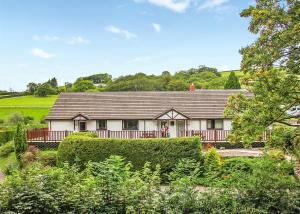 a large white house with a roof at Avalon Cottages in Llangynin