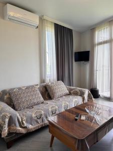 a living room with a couch and a coffee table at Golden Horizon in Ts'ikhisdziri
