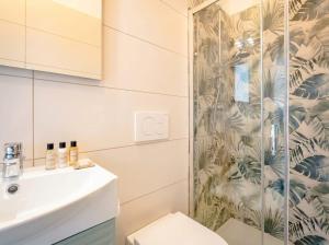 a bathroom with a shower and a toilet and a sink at SanVitoStea Seafront Apartments in San Vito +13 photos