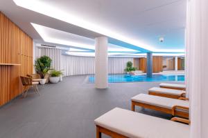 a hotel lobby with a pool in the background at Sport-V-Hotel in Hrotovice