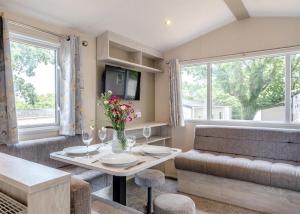 a living room with a table and a couch at Thorness Bay in Porchfield