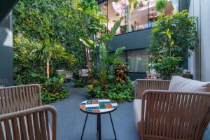 a patio with chairs and a table and plants at Sport-V-Hotel in Hrotovice