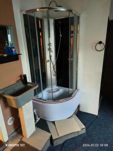 a bathroom with a shower and a sink at Centrum Panzió VIP in Kaposvár +18 photos