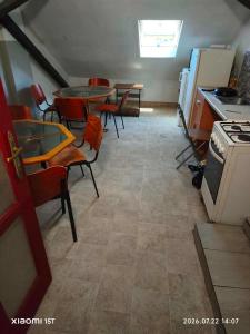 a kitchen with a table and chairs and a stove at Centrum Panzió VIP in Kaposvár