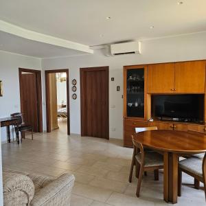 a living room with a table and a tv at B apartments LUXURY in Case Bruciate