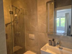 a bathroom with a shower and a toilet and a sink at Apartment & Room Aleksandra in Rab +12 photos