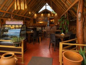 a restaurant with tables and chairs in a room at Wihara Cottage Sigiriya in Sigiriya