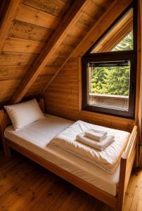 a bed in a room with a window at Scardus Lodge in Tetovo
