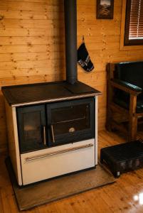 a woodburning stove in a room with at Scardus Lodge in Tetovo