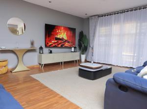 a living room with a large painting on the wall at Nassiwa Aisha in Kampala