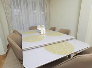 a white table with two candles on top of it at Nassiwa Aisha in Kampala +12 photos