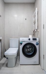 a washing machine in a bathroom with a toilet at New Gudauri LOFT in Gudauri