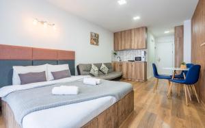a bedroom with a large bed and a living room at New Gudauri LOFT in Gudauri