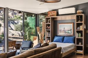 a bedroom with a bed and a couch at Mod West Ranch: 5-acre Boulder Playground in Pioneertown +92 photos