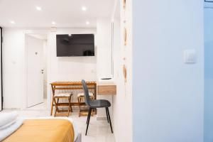a bedroom with a table and a chair in a room at Syntagma Luxury Suites 1 in Athens
