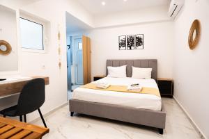 a bedroom with a bed and a desk and a chair at Syntagma Luxury Suites 1 in Athens