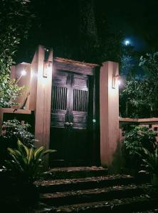 a front door of a house at night at Bản Bọc Chăm Chứng in Làng Vach +2 photos