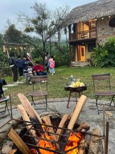 a fire pit in a yard with a group of people at Bản Bọc Chăm Chứng in Làng Vach