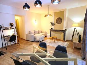 a living room with a couch and a table and chairs at 1A Liberte in Saint-Affrique