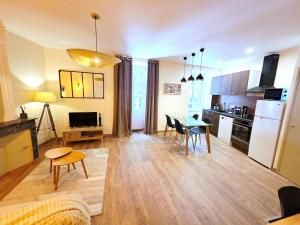 a living room with a table and a kitchen at 1A Liberte in Saint-Affrique +17 photos