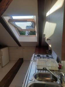 a kitchen with a stove and a skylight at Loft przy Starym Mieście in Jarosław