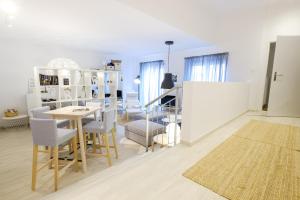 a living room with a dining room table and chairs at Apartments Bastova, Stela & Mia Apartments in Bratislava